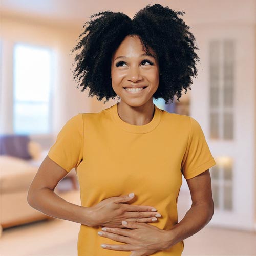 A woman similing with her hands held against her stomach